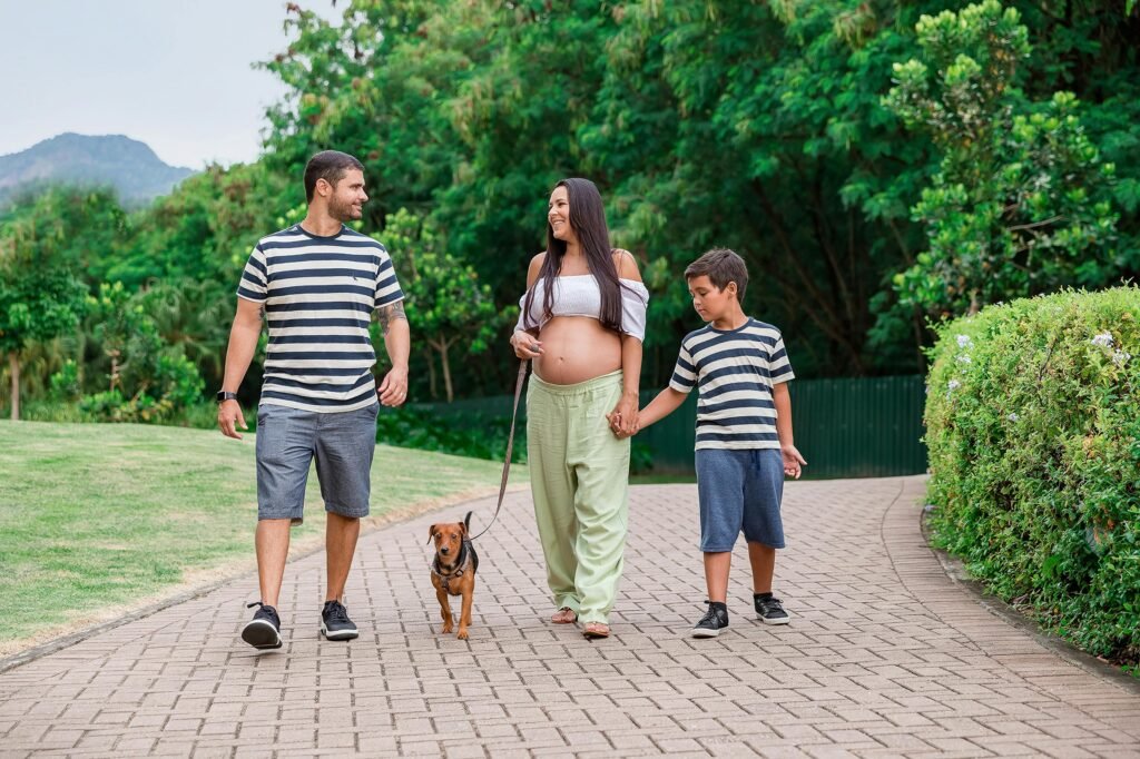 A joyful family walking their dog in lush greenery.